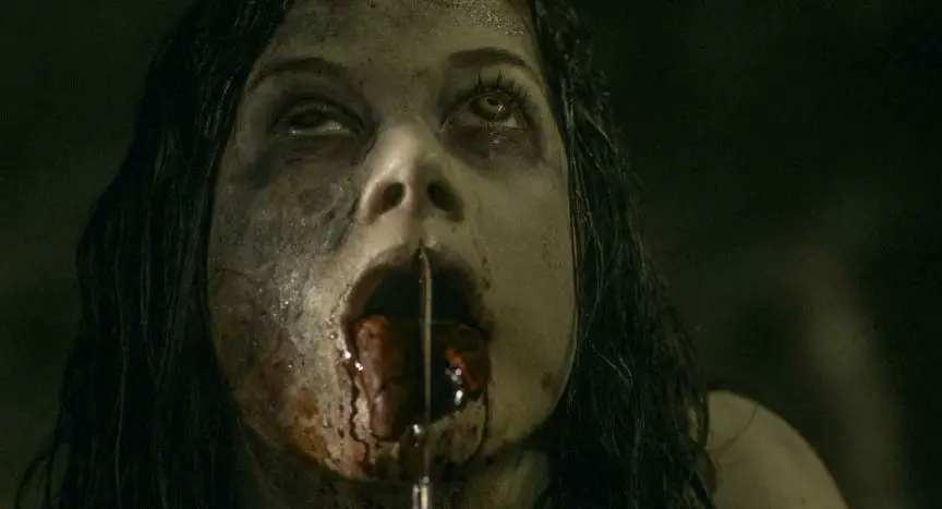 A possessed Maya (Jane Levy) slits her tongue in the remake Evil Dead 2013 - directed by Fede Alvarez.