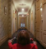 Danny and twin girls in hallway in Kubrick's The Shining