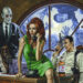 Cal Sits behind his desk with a lovely woman in front of him on the phone and a zombie beside him